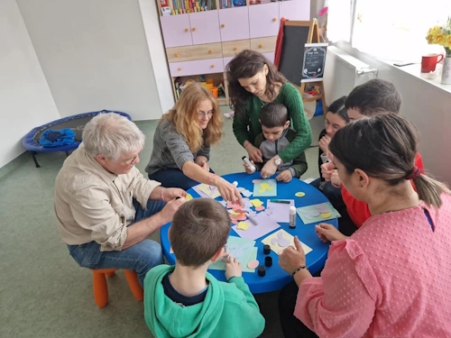 Humanity at Heart Asociatia Autism sitting around table